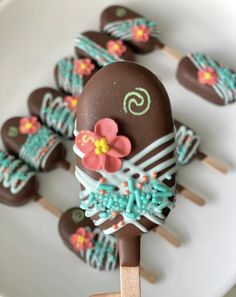 chocolate covered candy pops with flowers on them