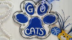 a blue and white cat paw ornament hanging on a wall