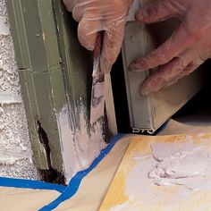 a man is painting the outside of a building