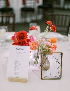 a table with flowers and menu cards on it