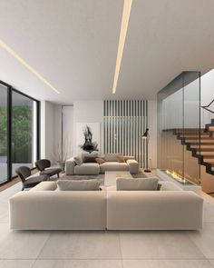 a modern living room with white couches and stairs