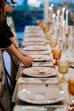 a long table is set with plates and silverware