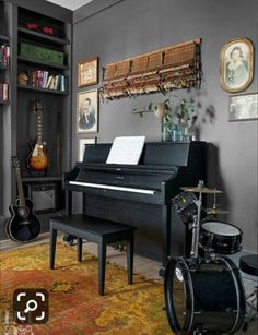 a room with a black piano and musical instruments