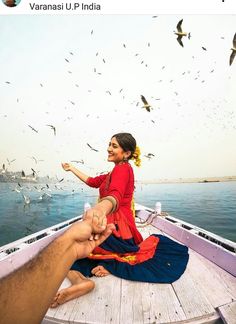 a woman sitting on top of a boat with birds flying over her and the caption reads, varanau u p india