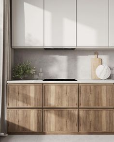 a kitchen with wooden cabinets and white counter tops, along with a potted plant