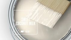 a paint can with a brush in it and the words sweet coconut milk on top