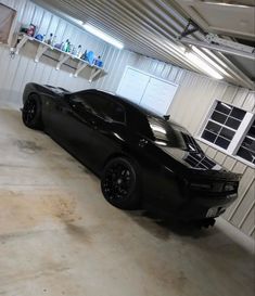 a black sports car parked in a garage