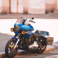 a blue motorcycle is parked on the street