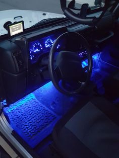 the interior of a vehicle with blue lights