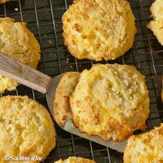 several biscuits on a cooling rack with a wooden spoon