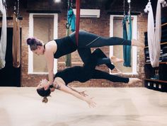 two women doing acrobatic tricks in a dance studio