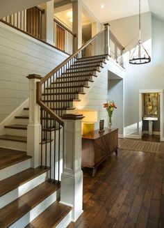 a staircase with wooden floors and white walls