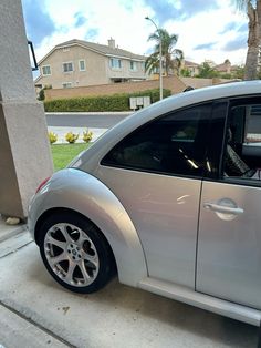 a silver car parked on the side of a street