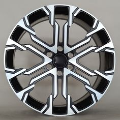 a black and white wheel on a gray background with the spokes painted to look like it is made out of metal