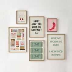 there are many framed pictures hanging on the wall with words and phrases in different frames