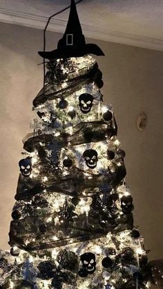 a decorated christmas tree in the shape of a witch's hat with skulls on it