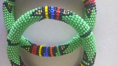 Beaded Bracelets | African Maasai Beaded Bracelets | African Jewelry | Zulu Beaded Bracelets | Ethnic Bracelets | Gift For Her | A Set Of Two These superbly crafted Zulu beaded bracelets are made of fine beads. The price is for a set of two bracelets. Main Color - Green. Size - Standard measurement is 7 - 8 inches. For smaller or larger bracelets please contact me. Available in different colors. Feel free to send me a convo or e-mail for any clarification. Thank you for visiting... Traditional Round Beaded Bracelets For Festival, Bohemian Handmade Bangle With Round Beads, Handmade Green Bangle For Festivals, Handmade Green Bangle For Festival, Handmade Bohemian Bangle With Round Beads, Bohemian Green Braided Bangle Bracelet, Green Bohemian Braided Bangle Bracelet, Green Hand-strung Braided Bracelet With Round Beads, Traditional Green Bracelets With Round Beads