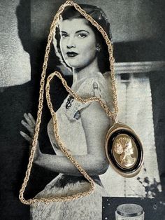 "Avon Vintage Metal Tone Gold Oval Cameo Pendant on 22\" Gold Chain. This piece is unique to cameos because it is made of metal. It has a black raised lucite border which really creates a focal point on the women's head. It measures 2 18\" in length and 1 m1/2\" in width. It is in good vintage condition. The has two rivets and is a gold tone lightly textured metal.  Free Shipping in the U.S. when Purchasing $35 or more. Complementary Vintage Gift Wrap on this Item. Please message me with questions about this listing.  No Returns or Exchanges." 1942 Vintage Necklace, Vintage Black Medallion Jewelry, Vintage Black Medallion Necklace, Black Vintage Necklace With Charm, Vintage Black Cameo Jewelry, Vintage Black Enamel Medallion Necklace, Vintage Medallion Necklace With Black Enamel, Vintage Black Enamel Necklaces For Evening, Vintage Black Enamel Necklace For Evening