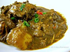 a white plate topped with meat covered in gravy