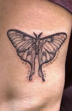 a butterfly tattoo on the side of a woman's stomach