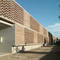 a brick building with an open door in the middle of it's side wall