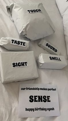 there are five bags on the bed that say, taste, smell and smell