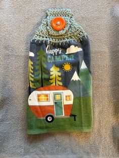 a towel with a camper on it hanging from the wall