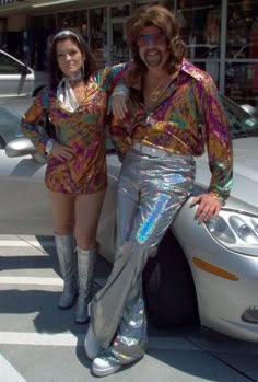 two women standing next to each other in front of a white car and posing for the camera