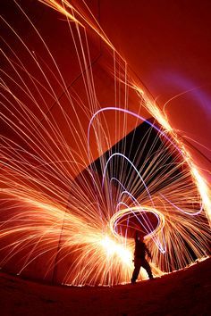 a man standing in front of a red sky with long exposure