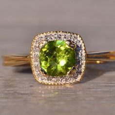 a close up of a ring with a green stone