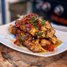 a white plate topped with chicken and vegetables