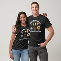 two people standing next to each other wearing t - shirts with donuts on them