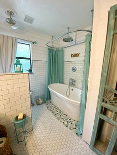 a bathroom with a claw foot tub and tiled floor