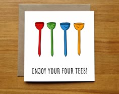 a card that says enjoy your four tees with three different colored plastic spoons