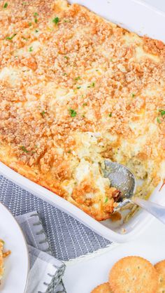 a casserole dish with cheese and crackers on the side