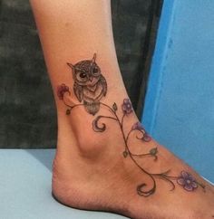 an owl tattoo on the foot of a woman