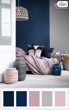 a bedroom with blue walls and white furniture in the corner, along with some baskets on the floor