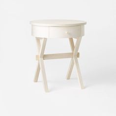 a small white table with two legs and a drawer on the top, against a white background