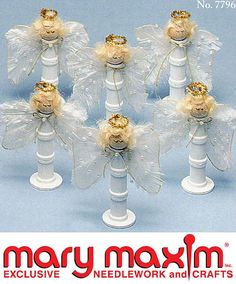 six white candles with angel wings and bows on each candle holder for christmas ornament decoration