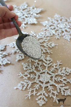 a person is spooning sugar on top of snowflakes