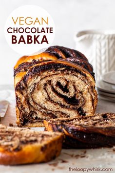 vegan chocolate bake with cinnamon swirl in the center and sliced up on a cutting board