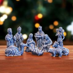 the nativity figurines have been placed in front of a christmas tree