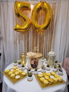 a table topped with lots of cupcakes and cake