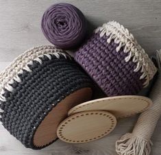 two crocheted baskets with yarn and a wooden spoon