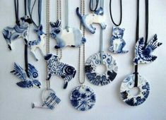 an assortment of blue and white porcelain items hanging on a wall