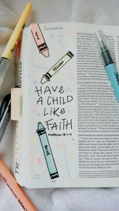 an open bible with pencils and markers on the page that says have a child like faith