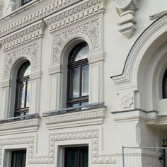 an ornate white building with arched windows