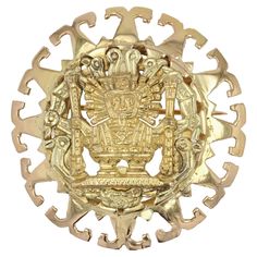 Brooch - Pendant in 18 karat yellow gold. Imposing retro transformable jewel, it presents a round openwork decoration, made of a frieze of motives in "T". In the center, a chiseled and engraved gold decoration represents an Aztec god surrounded by other motifs of the same origin. The retro gold jewel has a clasp to wear it as a pendant on a chain or a cord, and a pin with a safety clip to wear it as a retro gold brooch. Diameter : 4.2 cm, thickness : 7 mm approximately. Total weight of the jewel : 15,5 g approximately. Antique jewel - Mexican work from the 1960's. Our opinion : An antique gold jewel that will not go unnoticed. Ornate Yellow Gold Brooch For Ceremonial Use, Ornate Yellow Gold Brooches For Ceremonial Use, Ornate Yellow Gold Brooches For Ceremonial Occasions, Ornate Engraved Yellow Gold Brooches, Traditional Yellow Gold Collectible Brooch, Ceremonial Yellow Gold Brooch With Intricate Design, Ceremonial Engraved Yellow Gold Brooches, Engraved Yellow Gold Brooches For Ceremonial Occasions, Engraved Yellow Gold Brooches For Ceremonial Use