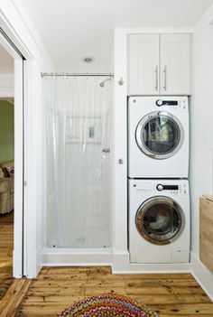 a washer and dryer in a room with wood flooring on the ground