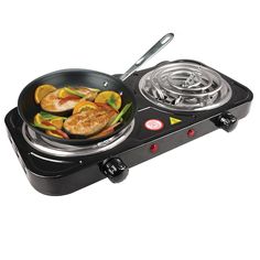 an electric skillet with food cooking on the top and two burners attached to it